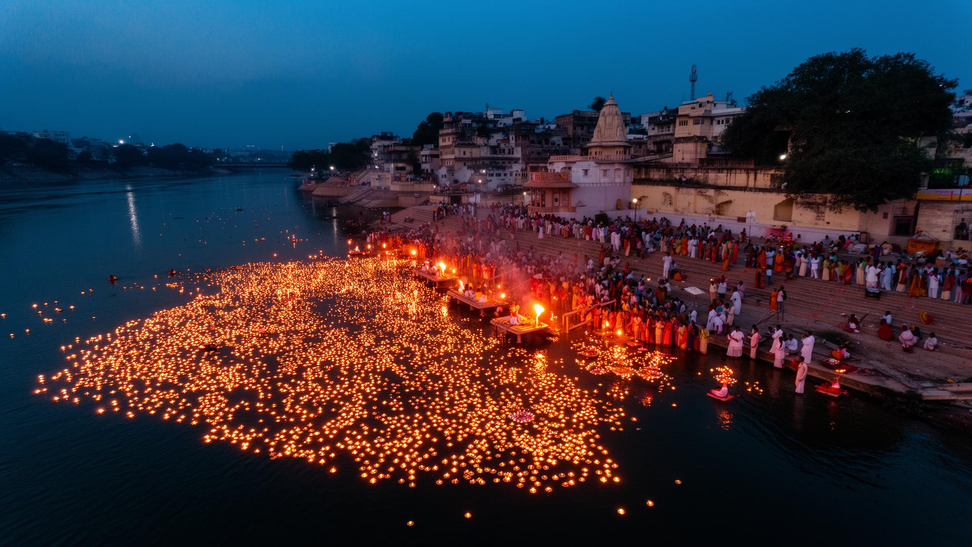 Aerial view of Ram Ghat Ujjain evening aarti with floating diyas on Shipra